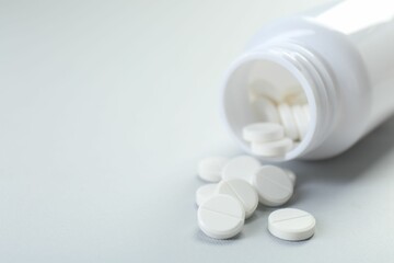 Medical bottle with antibiotic pills on grey background, closeup. Space for text