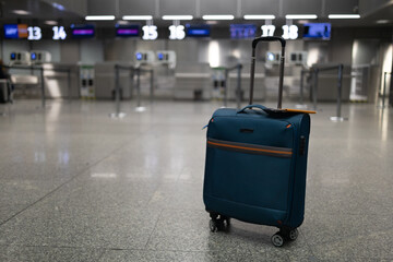 Travel, One suitcase in an empty airport hall, traveler case in the departure airport terminal waiting for the area, vacation concept, blank space for text message or design. High quality photo