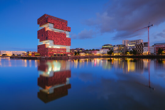 MAS museum, Antwerp, Belgium. Cityscape during sunset.  Reflection on the water surface. MAS museum near the water in the bay. Architecture of the Belgium. Travel photography.