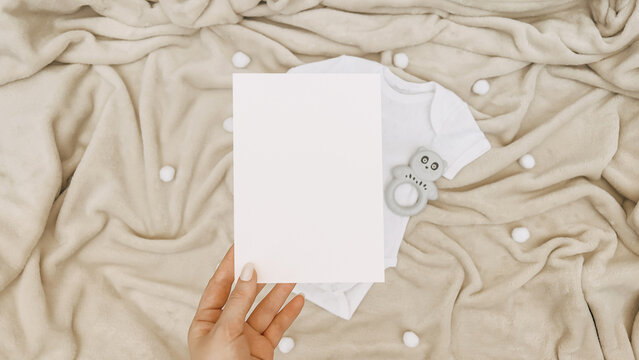 Neutral Baby Announcement Mockup with Blank Card, White Onesie, and Fluffy Beige Blanket – Perfect for Baby Shower Invitations and Designs - Powered by Adobe