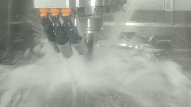 Demonstrate of CNC milling machine cutting the steel parts with water coolant method. Steel cut include water cooling during steel forming to prevent from damage using automate CNC in modern factory.