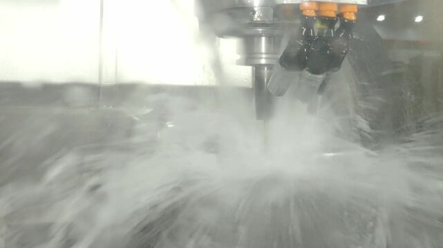 Demonstrate of CNC milling machine cutting the steel parts with water coolant method. Steel cut include water cooling during steel forming to prevent from damage using automate CNC in modern factory.