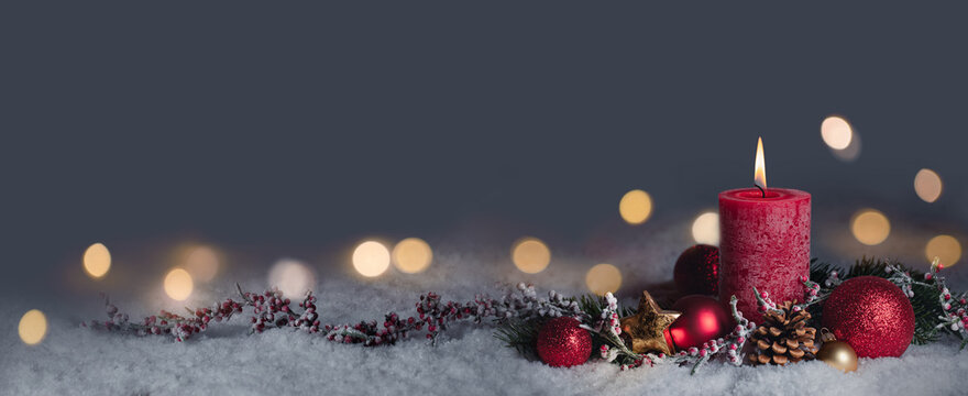 Red Christmas Candle - First Advent Sunday - 1. Advent or Xmas decoration with snow background and magic golden  lights - Panorama, Banner, Header with copy space, Blank greeting card