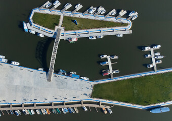 Aerial view with many colorful boats moored at the pontoon