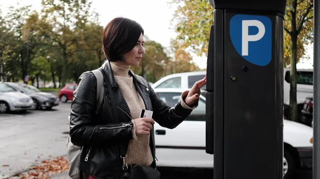 Woman Pays For Car Parking Via Parking Meter Using Credit Card