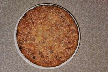 Cottage cheese casserole with raisins, decorated with sesame seeds. Homemade cakes.