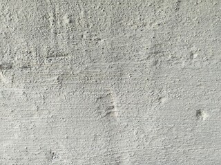 Texture, fragment of a wall with a jerking paint of orange, white, brown and yellow colors