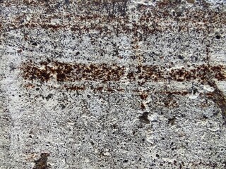 Texture, fragment of a wall with a jerking paint of orange, white, brown and yellow colors
