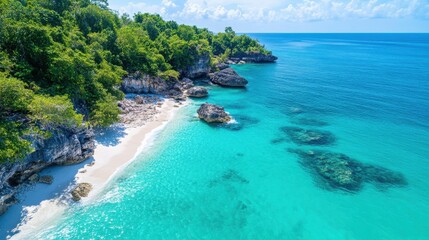 A tranquil beach scene featuring clear turquoise ocean water and a lush, green coastal landscape, perfect for a tropical escape or vacation ambiance.