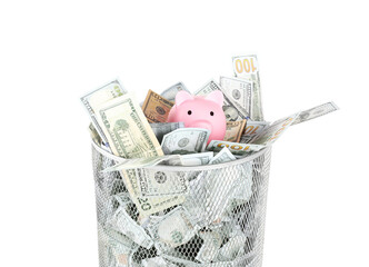 Many dollar banknotes and piggy bank in trash bin isolated on white