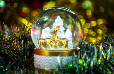christmas decoration snowball snow globe with bright lights dots on blur background xmas tree gold