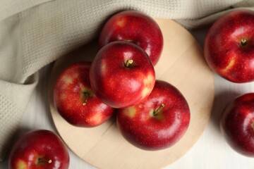 Fresh ripe red apples on white table