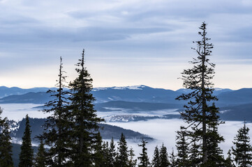 Distant high mountains in snow and fog.