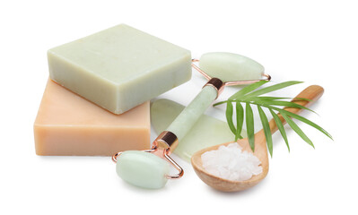 Face roller, soap bars and sea salt isolated on white