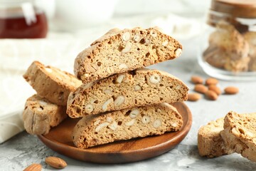 Traditional Italian almond biscuits (Cantucci) on grey textured table, closeup