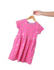 Woman holding hanger with pink baby dress on white background, closeup