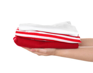 Woman holding stack of clothes on white background, closeup