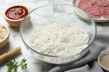 Making calzone pizza. Different ingredients on white marble table, closeup