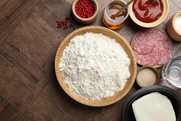 Making calzone pizza. Different ingredients on wooden table, flat lay
