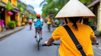 A cyclist wearing a traditional conical hat rides down a vibrant, busy street lined with colorful buildings and palm trees, suggesting cultural harmony and exploration.
