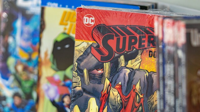 9th Comic Con Convention In GUAYAQUIL, ECUADOR - AUG 04, 2024 - Close-up of DC Comics graphic novels on a shelf, showcasing vibrant covers including Superman and other iconic superheroes.
