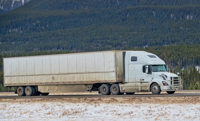 Heavy Cargo on the Road. A truck hauling freight along a highway. Taken in Alberta, Canada