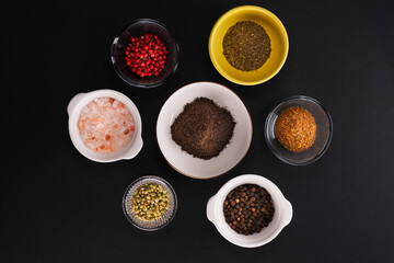spices and herbs on black background