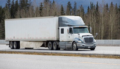 Heavy Cargo on the Road. A truck hauling freight along a highway. Taken in Alberta, Canada