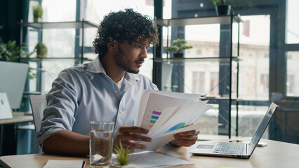 Stressed sad Arabian Indian man anxious male worker executive manager working at office check...