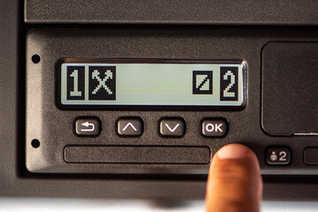 Fototapeta premium Digital tachograph display on a truck showing the first driver punching other jobs and the second driver on call.