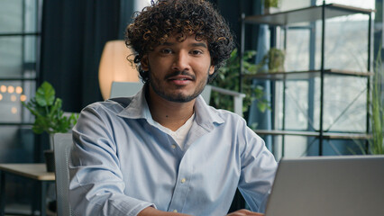 Business portrait Indian arabian man smiling male businessman cheerful guy gen z working on laptop...