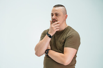 Thoughtful man in casual clothing contemplating an idea with a pensive expression