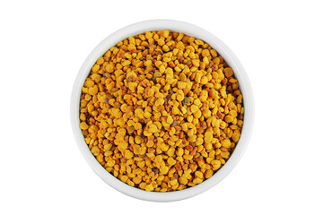 Bee pollen grains in ceramic bowl isolated on white background. Top view. Flat lay