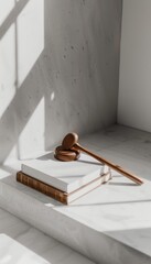 A gavel on law books  symbol of justice and authority against a crisp white background