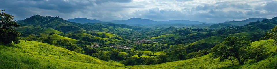 Obraz premium Verdant Valley: A peaceful valley nestled between rolling hills, home to a quiet village and lush vegetation.