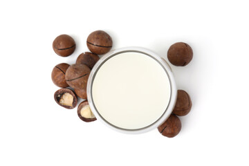 Glass of macadamia milk and nuts isolated on white, top view