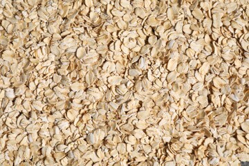 Pile of oat flakes as background, top view