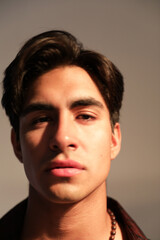 Fototapeta premium Headshot of young handsome man posing shirtless over white background. Vertical.