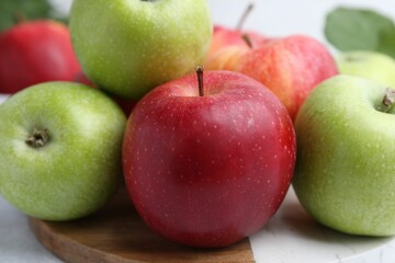 Many fresh ripe apples on table, closeup