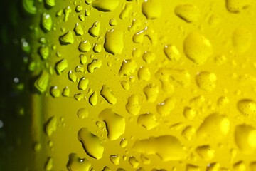 Water drops on color glass surface, macro view