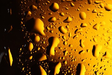 Water drops on color glass surface, macro view