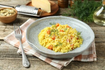 Delicious pumpkin risotto served on wooden table, closeup