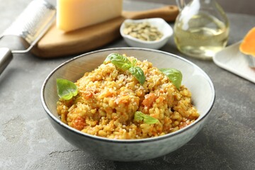 Delicious pumpkin risotto on grey table, closeup