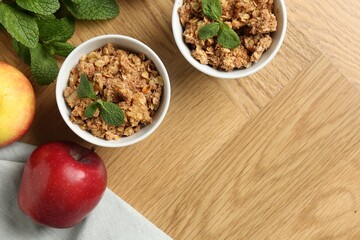 Delicious apple crisp, fresh fruits and mint on wooden table, flat lay. Space for text
