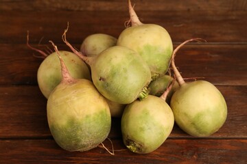 Whole fresh turnips on wooden table, closeup