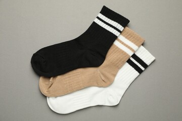 Different soft socks on light grey background, flat lay