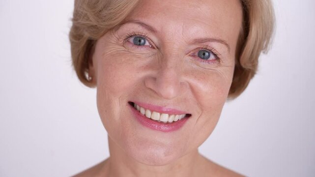 A joyful and cheerful middle-aged woman smiles warmly, radiating positivityband confidence. Self-love and graceful aging