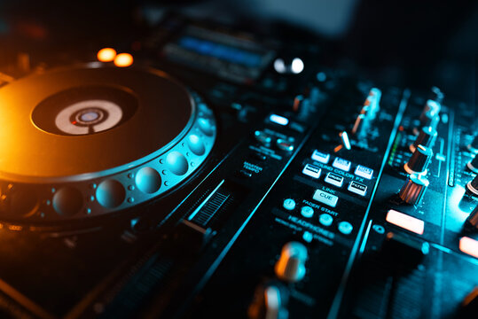 closeup of professional digital pioneer dj decks and audio mixer equipment ready for party in nightclub
