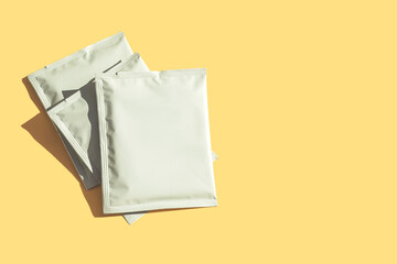 Packaging drip bag, three simple coffee isolated on colorful light yellow background. Mock up,...