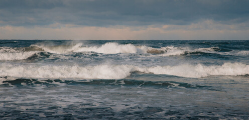 Sea Waves Crashing Under a Cloudy Sky